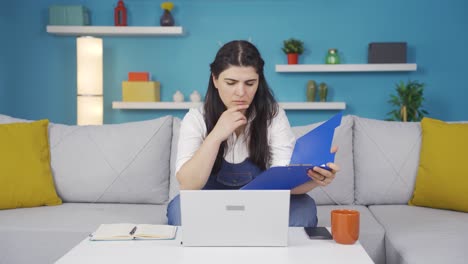 The-woman-looking-at-the-documents-is-thoughtful.