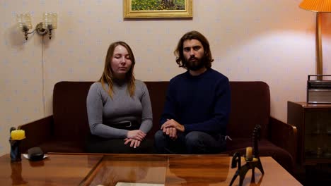 couple sitting on a sofa in a vintage living room