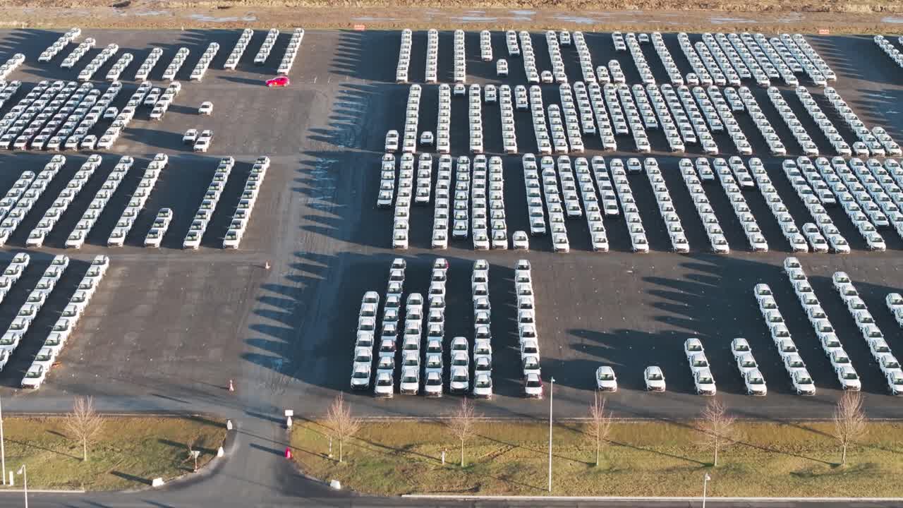 Aerial - mass production vehicles parked in straight line and rows