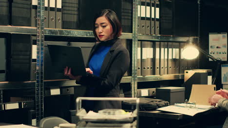 Detective-evaluating-old-archived-folders-to-organize-all-cases-based-on-crimes