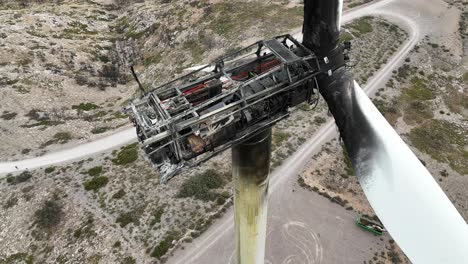 extreme closeup view of a wind turbine completely destroyed by a fire