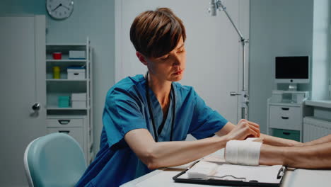 nurse bandaging a patient's wrist/ankle