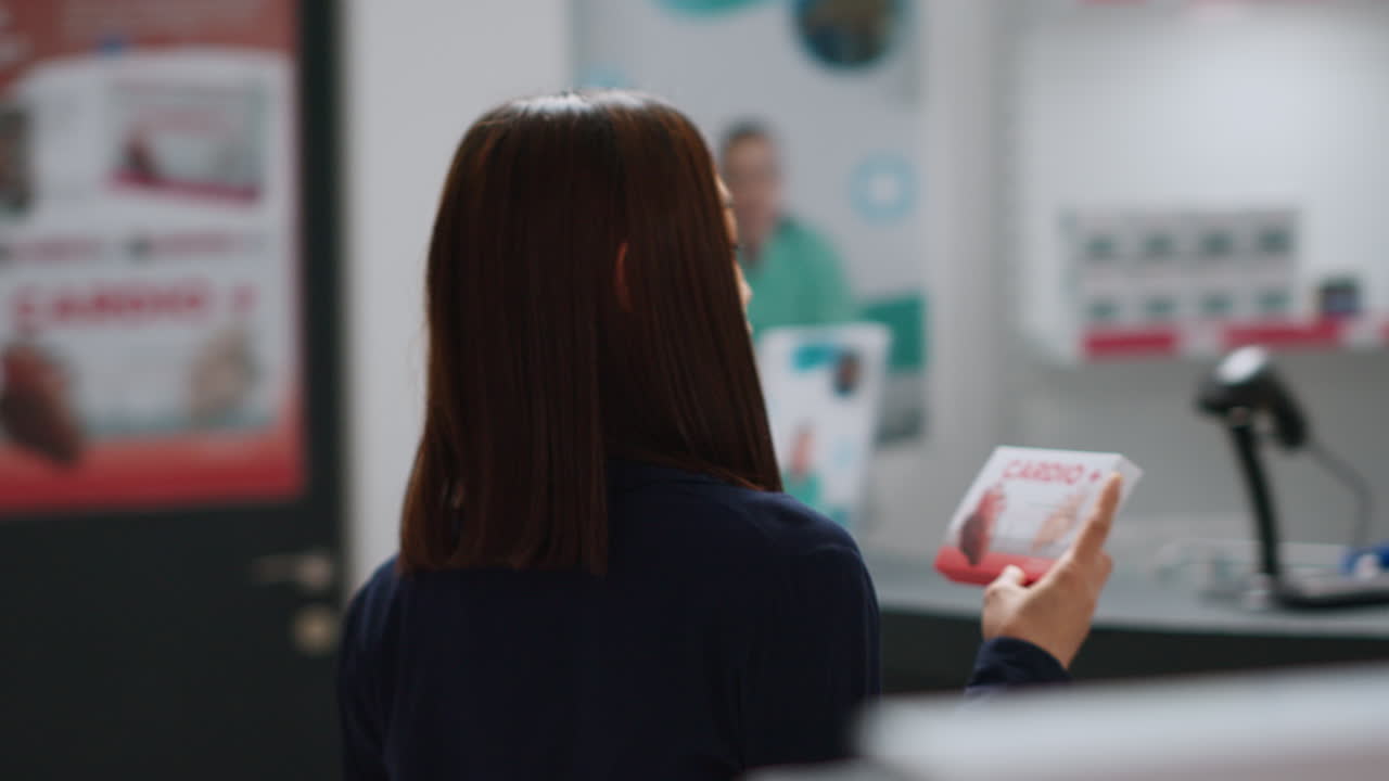 Customer consulting with pharmacist about medication