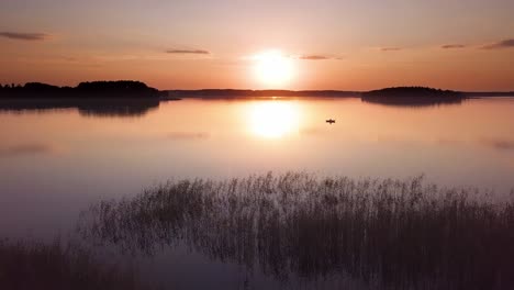 sunset over lake aerial. slow rise shot