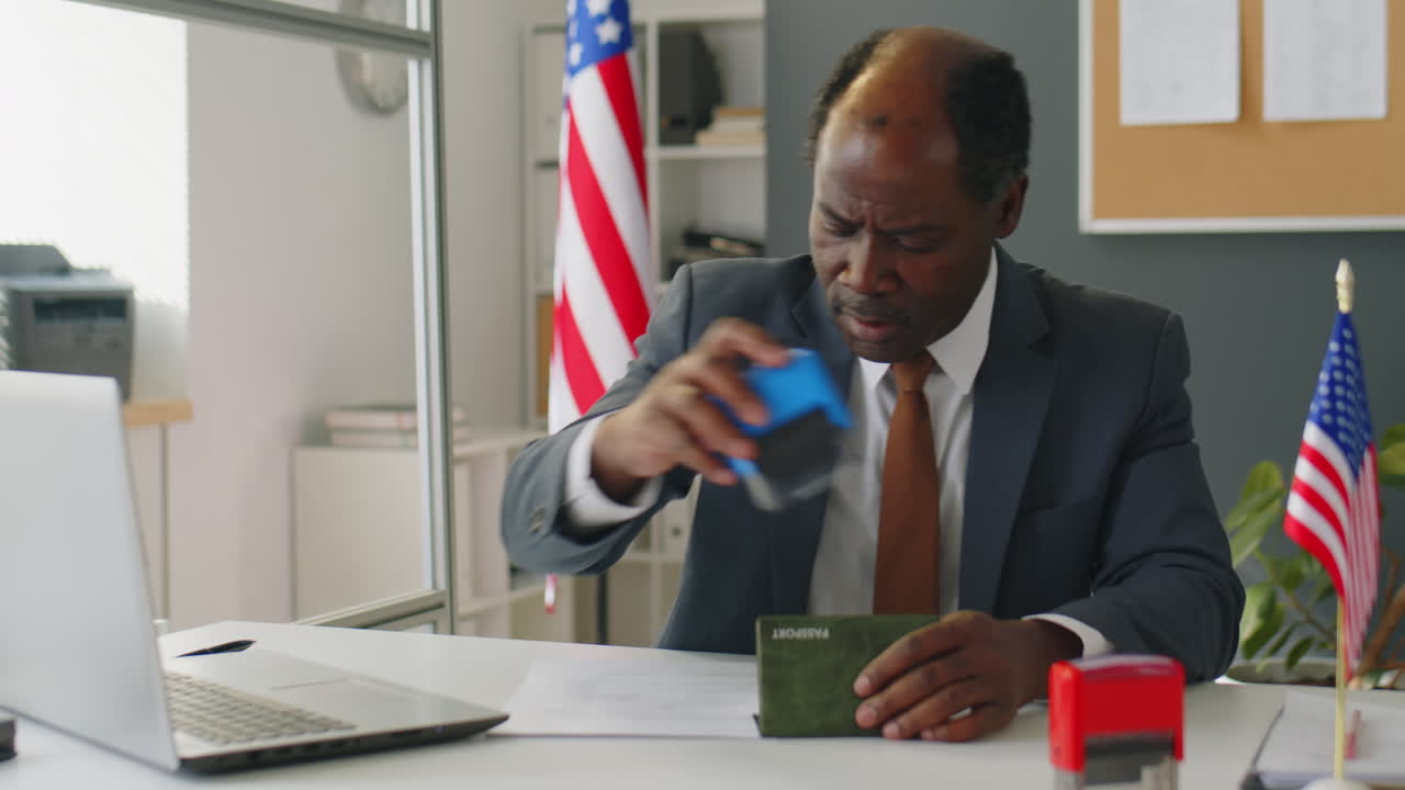 African American Visa Officer Working with Documents