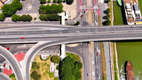cars move by the roads, bridges and freeways. drone footage over the waterfront of the danube in bratislava, slovakia