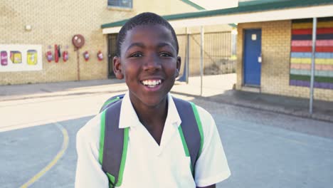 portrait of a young schoolboy smiling in playground 4k