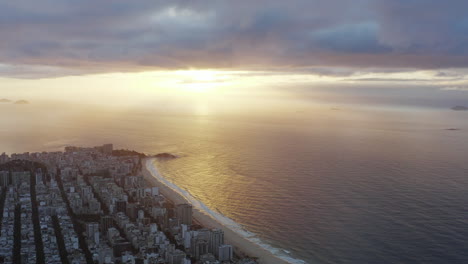 Aerial-view-of-sunrise-in-Copacabana-coast-and-ocean,-Brazil