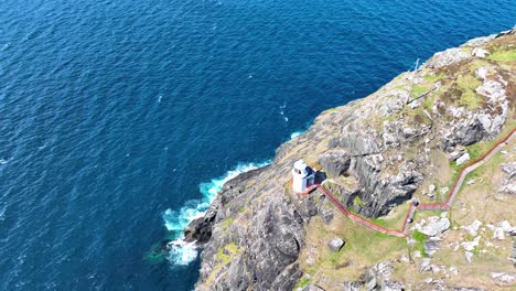 ireland epic locations drone flying overhead sheep’s head lighthouse and dramatic sea cliffs plunging to the sea west corks dramatic coastline