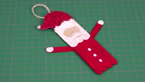 Figure-of-santa-claus-made-with-popsicle-sticks-on-a-cutting-mat