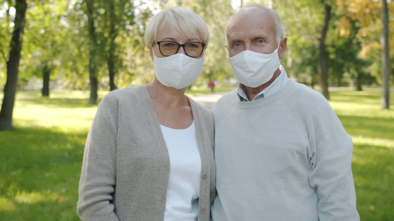 Elderly Couple Wearing Masks in a Park