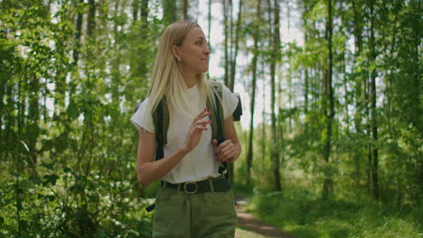 woman young blonde looks at forest beauty while traveling