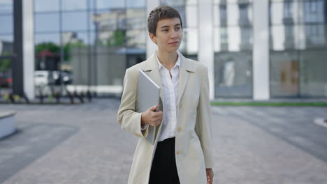 businesswoman walking with laptop