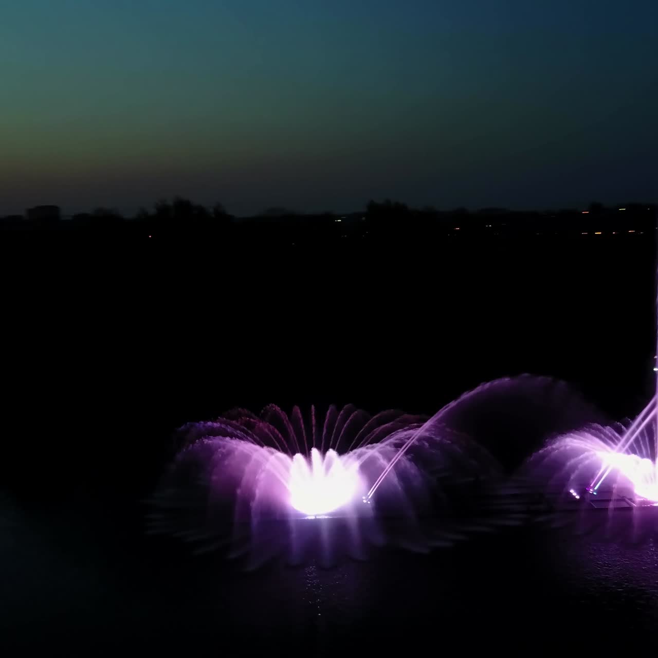 Musical Fountain Show. Aerial shot of the beautiful fountain show with reflection on water at night