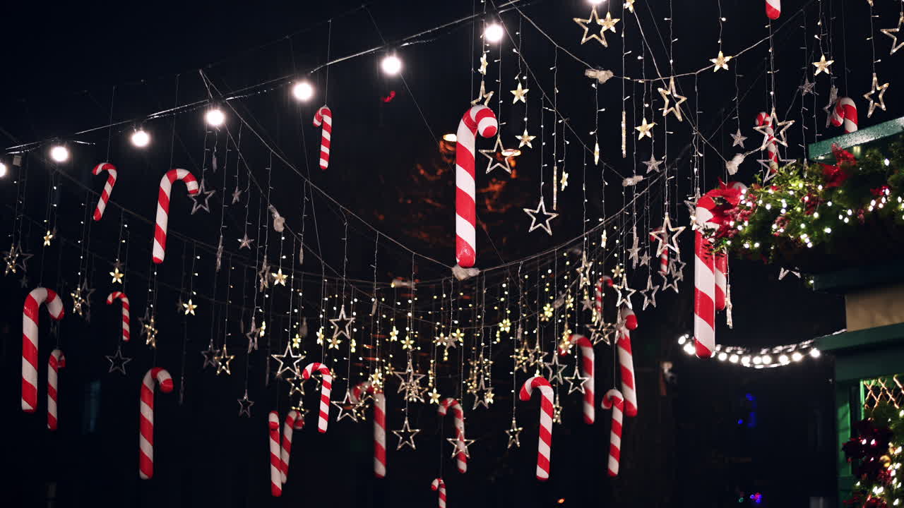 Enjoy the festive atmosphere of a holiday market featuring colorful candy canes and twinkling stars illuminating the night sky. Perfect for celebrating the season