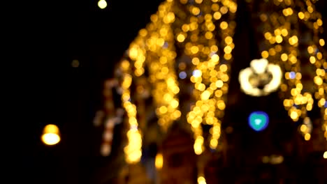 bokeh christmas lights nighttime at street as time lapse