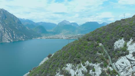 Breathtaking-beauty-of-Lake-Garda-from-drone-aerial-perspective,-showcasing-the-lush-greenery-and-perfect-trails-for-hiking-and-walking