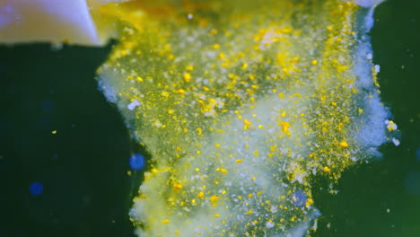 pill dissolving in liquid, creating a colorful mix of bubbles and particles