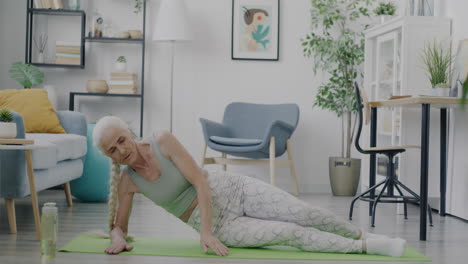 senior woman doing side plank exercise at home
