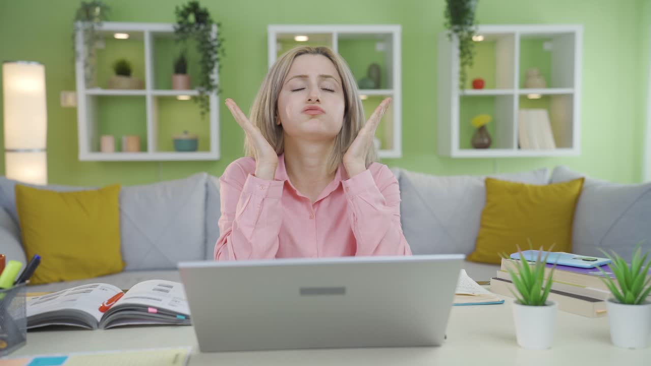 University student girl is upset by what she sees on laptop.