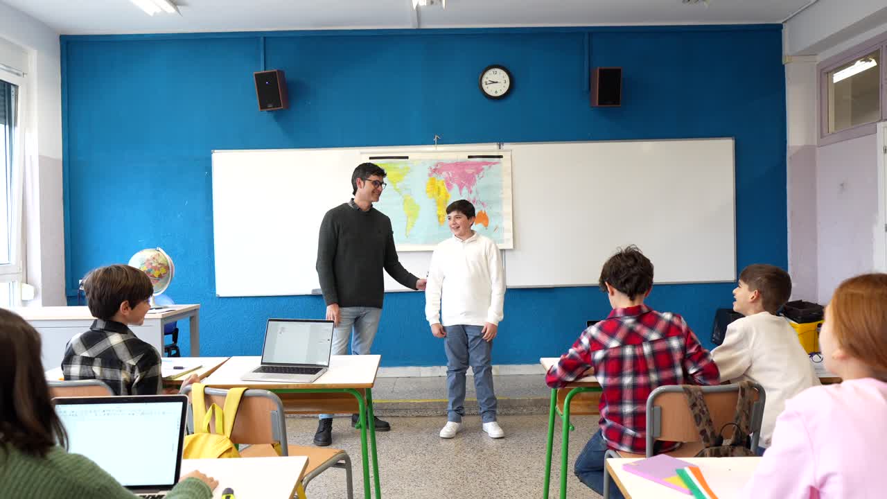 Teacher presenting with student in classroom