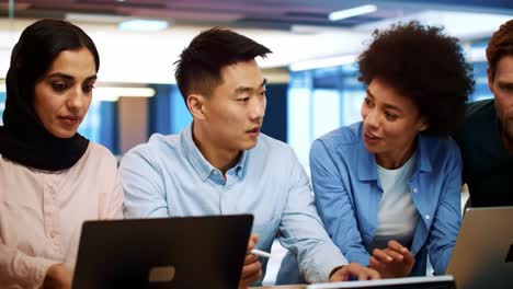 diverse team working together on laptops