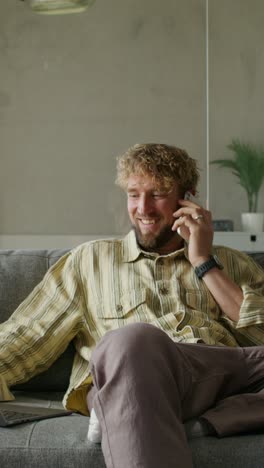 man talking on phone while working from home