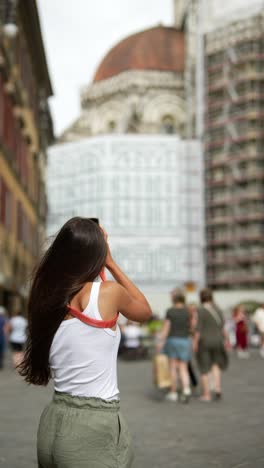 woman taking photo in florence, italy