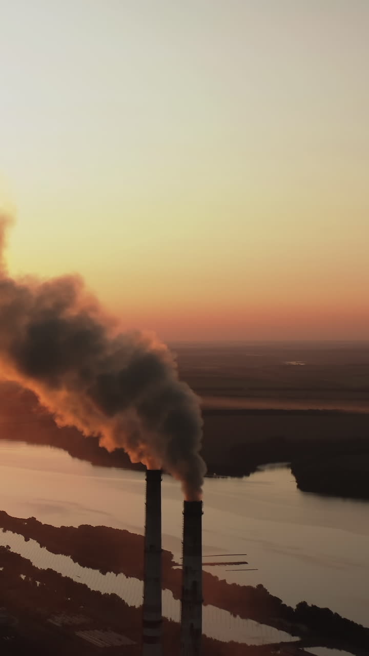 Plant with smoking smokestack. Problem of environmental pollution by factories. Vertical video