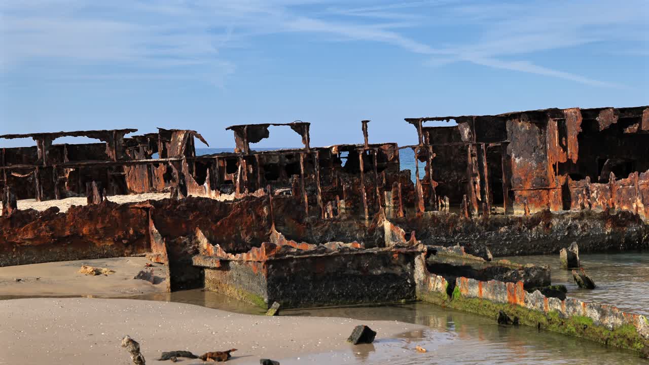 Close-up of the Rusty Hull of an Old Shipwreck on the Beach