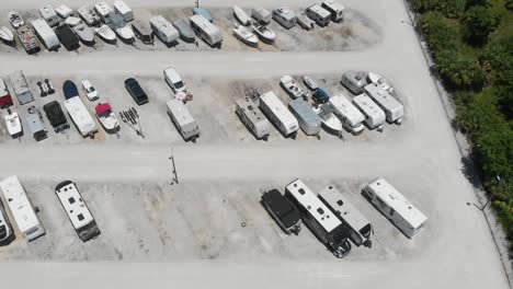 backward drone aerial over storage lot for boats and campers