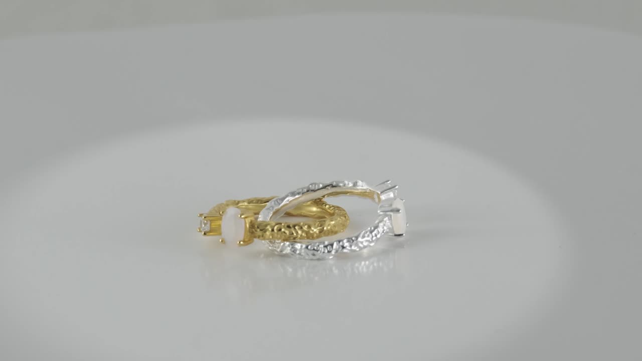 Opal adjustable rotating golden and silver rings isolated on white background