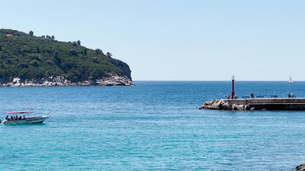 A speedboat with people entering the Old town port in Dubrovnik during the summer, Dalmatia, Croatia
