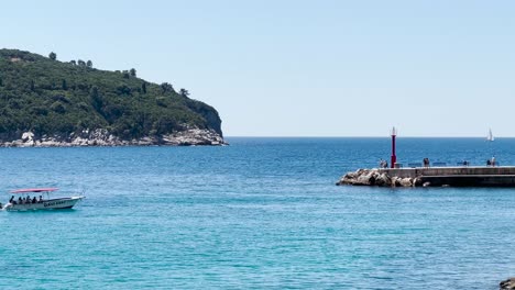 a speedboat with people entering the old town port in dubrovnik during the summer, dalmatia, croatia
