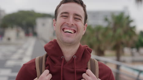 portrait attractive young man laughing enjoying successful vacation lifestyle independent male student summer travel in urban city seaside background slow motion