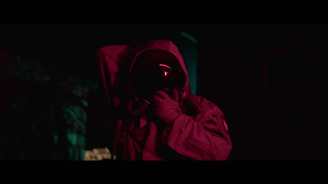 Person in Protective Gear in a Dark Location