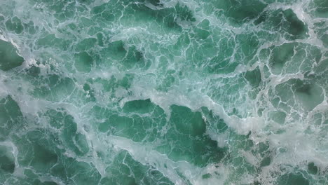 aerial view of ocean waves and foam