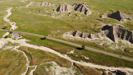 drone aerial view of cars on road in badlands national park, south dakota, usa