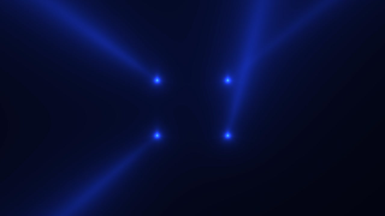 Glowing blue spotlight beams on stage