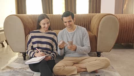 Happy-Indian-couple-counting-money