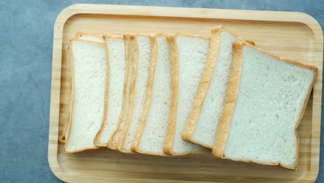 sliced white bread on a wooden board