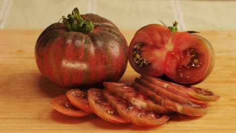 sliced heirloom tomato on wooden cutting board