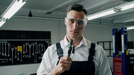 mechanic inspecting a car part in a workshop