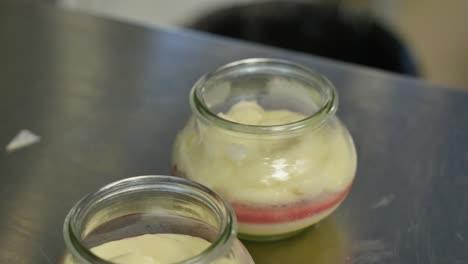 preparing layered desserts in glass jars