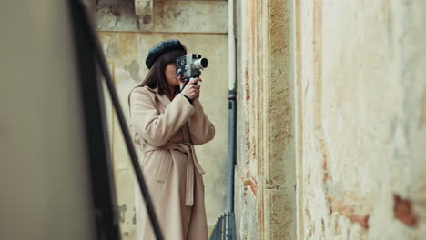 woman using a vintage film camera outdoor in a small italian town