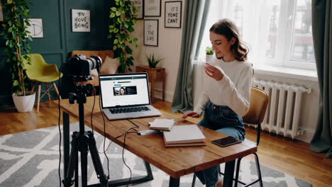 woman vlogger recording a video in her home studio