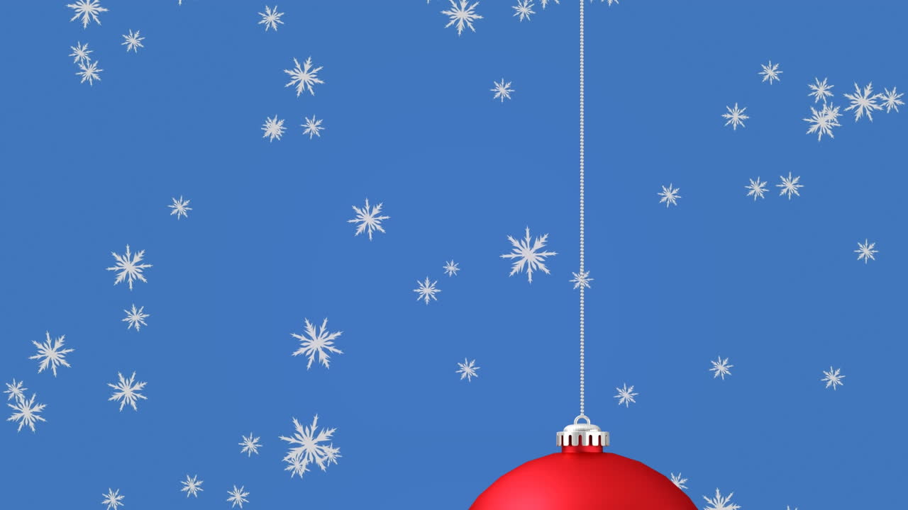 animación de nieve cayendo sobre la joya de navidad roja sobre fondo azul