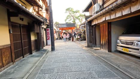 tourists explore traditional district with shops and rickshaw.