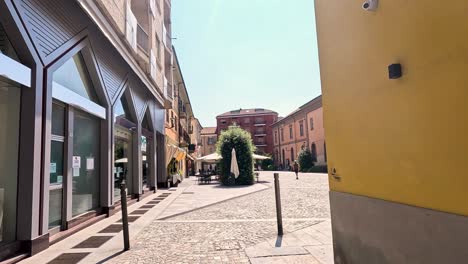 quiet alleyway with shops and historic buildings