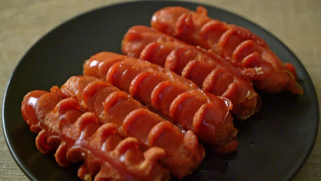 deep fried sausage skewer on black plate